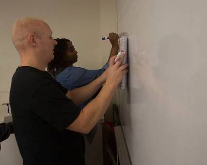 students working at white board