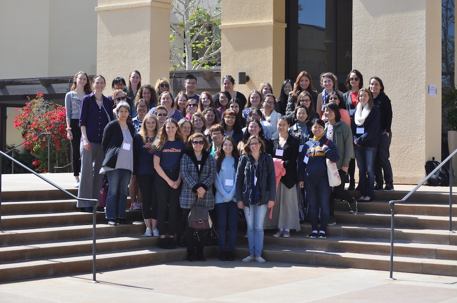 Participants of a previous WimSoCal symposium stand on steps